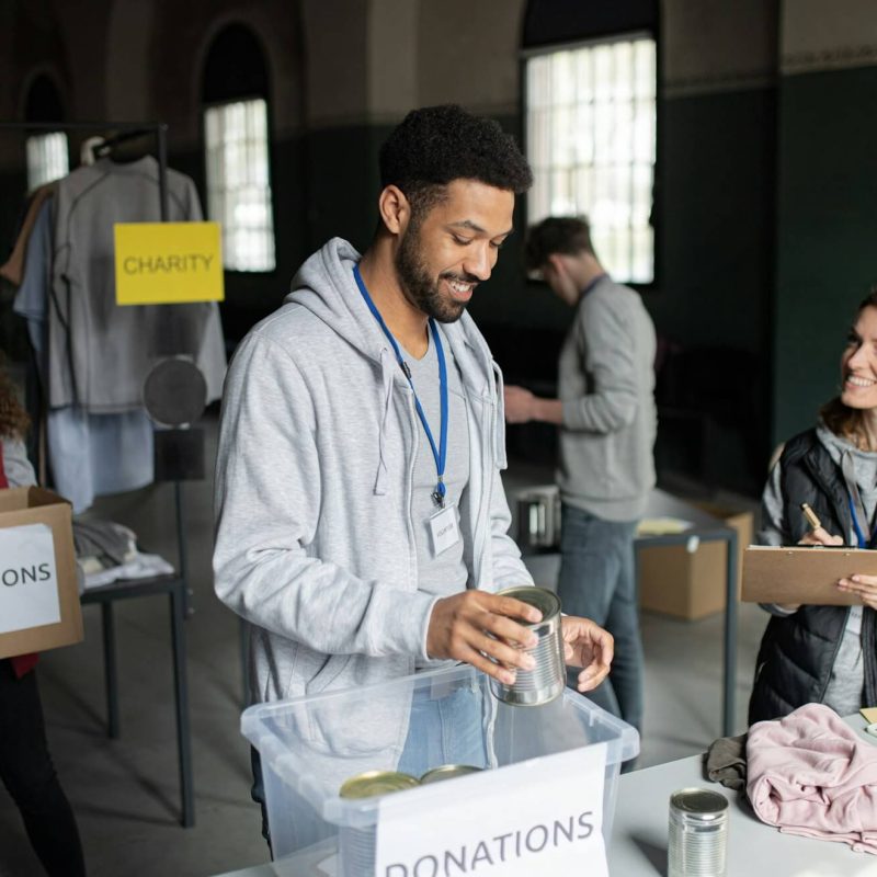 volunteers-working-in-community-charity-donation-center-sorting-out-clothes-and-canned-food-.jpg